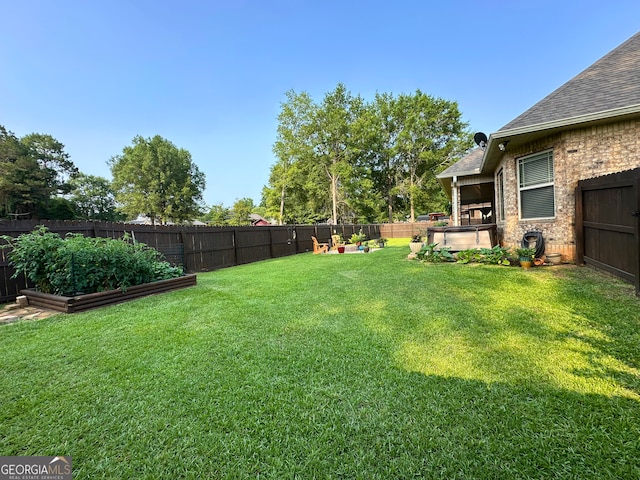 307 Legacy Park Dr, Perry, GA 31069 - fenced backyard with a vegetable garden and a hot tub