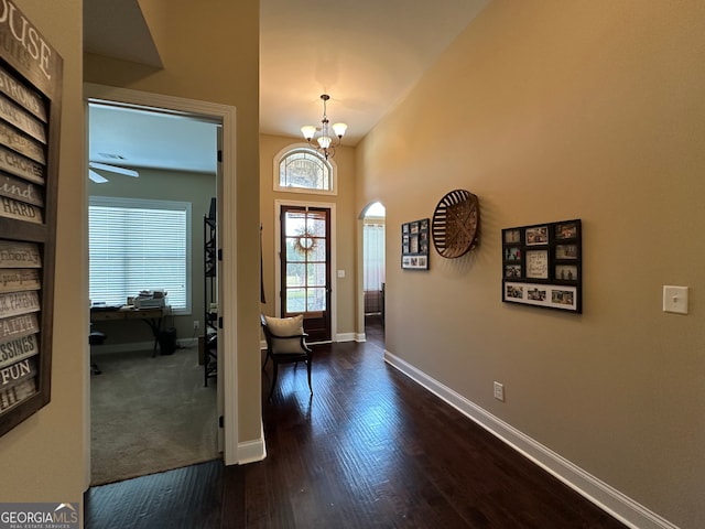 307 Legacy Park Dr, Perry, GA 31069 - entrance foyer featuring dark wood finished floors, a chandelier, and arched walkways