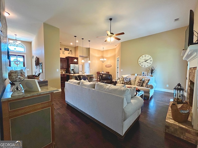 307 Legacy Park Dr, Perry, GA 31069 - living area featuring a ceiling fan, dark wood finished floors, a fireplace with raised hearth, a chandelier, and recessed lighting