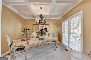 2123 Floral Ridge Dr, Dacula, GA 30019 - dining room featuring a chandelier, plenty of natural light, coffered ceiling, and beam ceiling