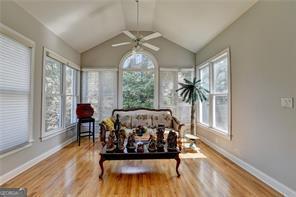 2123 Floral Ridge Dr, Dacula, GA 30019 - sunroom / solarium with plenty of natural light, wood finished floors, and lofted ceiling