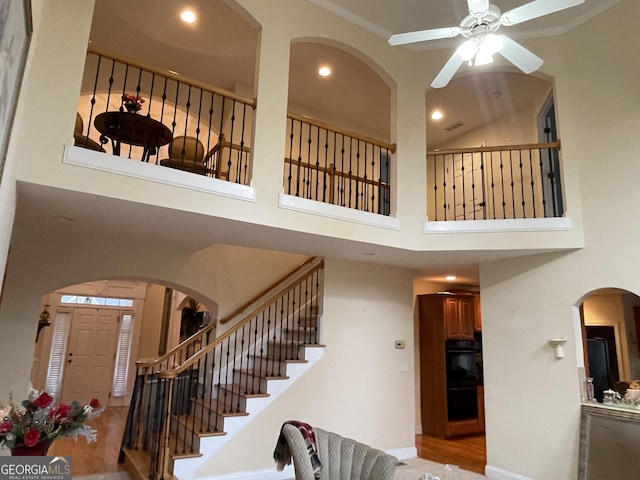 2123 Floral Ridge Dr, Dacula, GA 30019 - stairs with arched walkways, a high ceiling, recessed lighting, ceiling fan, and wood finished floors