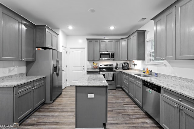 102 Brookstone Way, Rincon, GA 31326 - kitchen featuring appliances with stainless steel finishes, gray cabinets, a sink, a kitchen island, and dark wood-style flooring