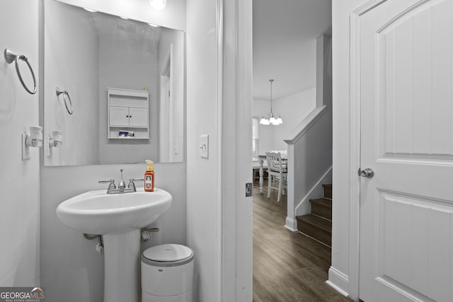 102 Brookstone Way, Rincon, GA 31326 - half bath featuring wood finished floors, a chandelier, and toilet