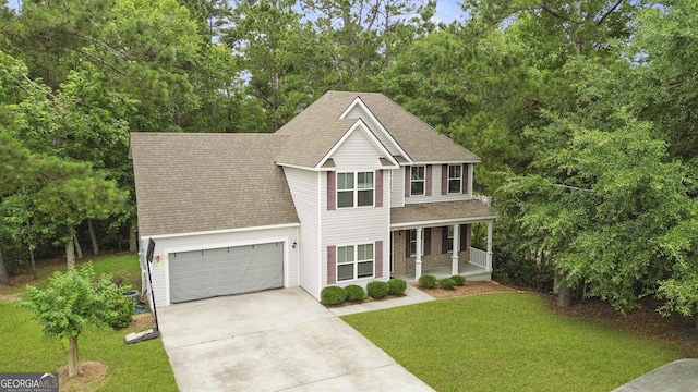 102 Brookstone Way, Rincon, GA 31326 - view of front of home featuring driveway, a porch, a shingled roof, and a front yard