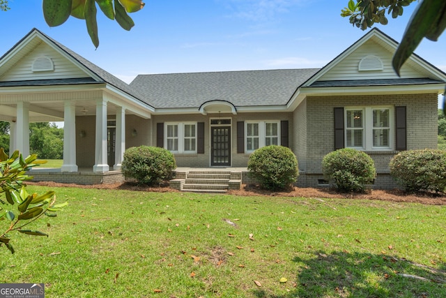 7443 Church St, Bartow, GA 30413 - view of front facade featuring a front lawn, brick siding, a porch, crawl space, and roof with shingles