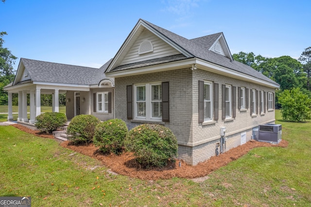 7443 Church St, Bartow, GA 30413 - view of front facade with brick siding, a front lawn, central air condition unit, and a shingled roof