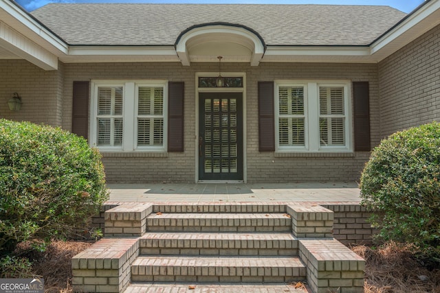 7443 Church St, Bartow, GA 30413 - doorway to property with brick siding and roof with shingles