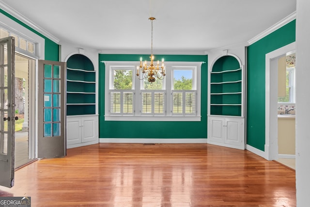 7443 Church St, Bartow, GA 30413 - unfurnished dining area featuring ornamental molding, built in features, a chandelier, wood finished floors, and baseboards