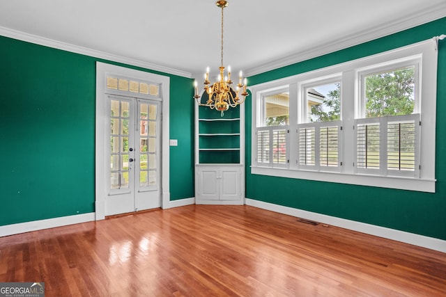 7443 Church St, Bartow, GA 30413 - unfurnished dining area featuring ornamental molding, a chandelier, wood finished floors, baseboards, and french doors