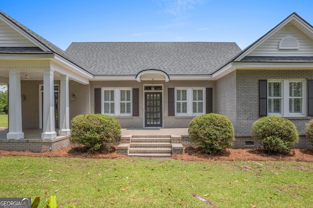 7443 Church St, Bartow, GA 30413 - property entrance with covered porch, brick siding, and a yard