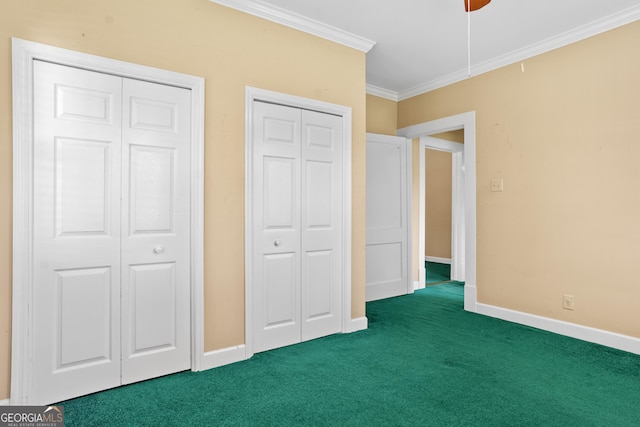 7443 Church St, Bartow, GA 30413 - unfurnished bedroom featuring carpet flooring, two closets, ornamental molding, baseboards, and a ceiling fan
