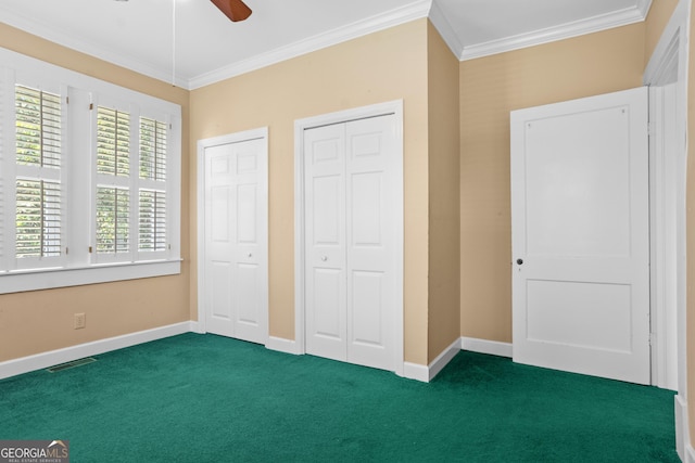 7443 Church St, Bartow, GA 30413 - unfurnished bedroom featuring two closets, carpet flooring, crown molding, baseboards, and ceiling fan