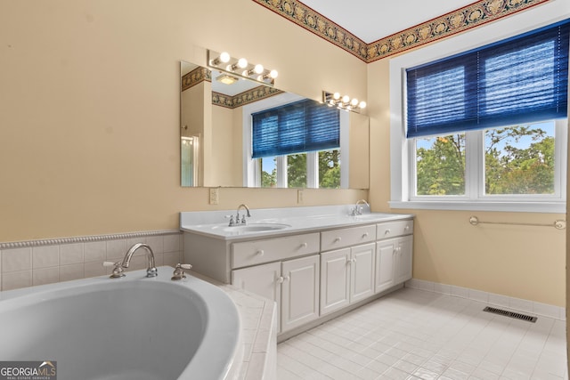 7443 Church St, Bartow, GA 30413 - bathroom featuring a bath, double vanity, tile patterned flooring, and baseboards