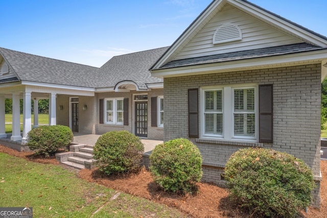 7443 Church St, Bartow, GA 30413 - view of front of home with brick siding, a porch, and roof with shingles