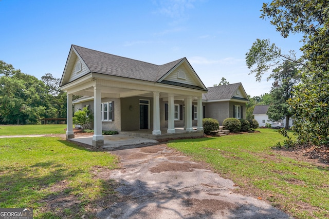 7443 Church St, Bartow, GA 30413 - greek revival inspired property with covered porch, brick siding, roof with shingles, and a front lawn