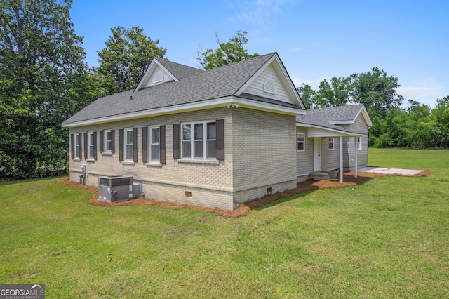 7443 Church St, Bartow, GA 30413 - view of side of home with a shingled roof, crawl space, a lawn, and central air condition unit