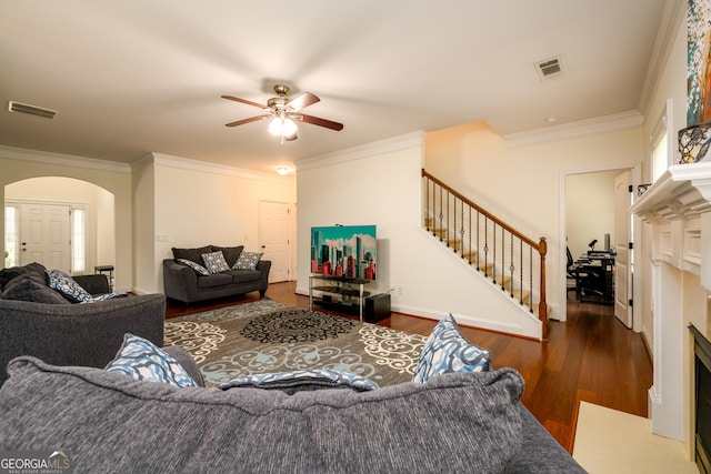 1076 Scenic Park Trl, Lawrenceville, GA 30046 - living room featuring a ceiling fan, arched walkways, stairway, ornamental molding, and wood finished floors