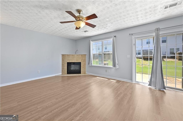 695 Georgetown Ct, Jonesboro, GA 30236 - unfurnished living room featuring wood finished floors, baseboards, ceiling fan, and a fireplace