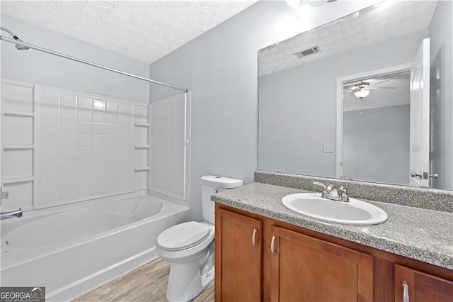 695 Georgetown Ct, Jonesboro, GA 30236 - bathroom with a textured ceiling, toilet, vanity, shower / bathtub combination, and a ceiling fan