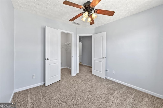 695 Georgetown Ct, Jonesboro, GA 30236 - unfurnished bedroom with carpet floors, a spacious closet, baseboards, a textured ceiling, and a closet