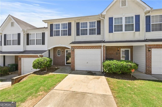 695 Georgetown Ct, Jonesboro, GA 30236 - view of property with brick siding, driveway, a garage, and stucco siding