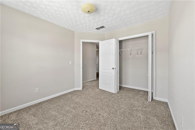 695 Georgetown Ct, Jonesboro, GA 30236 - unfurnished bedroom with carpet flooring, baseboards, a closet, and a textured ceiling