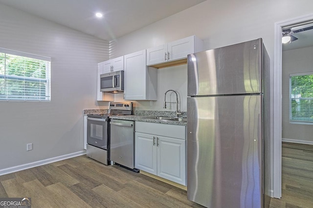 2065 Freeman St, Macon, GA 31201 - kitchen with stainless steel appliances, a sink, dark wood-type flooring, and white cabinetry
