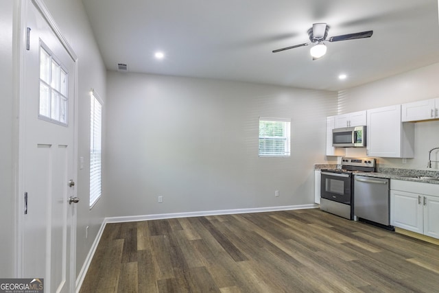 2065 Freeman St, Macon, GA 31201 - kitchen featuring stainless steel appliances, dark wood-type flooring, white cabinets, ceiling fan, and a sink