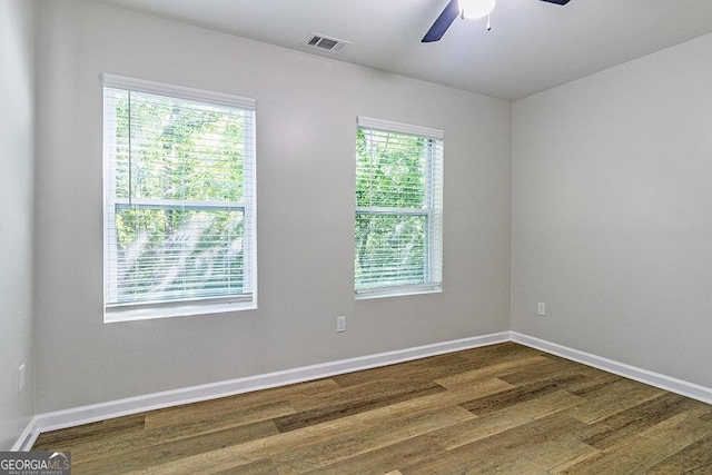 2065 Freeman St, Macon, GA 31201 - spare room with dark wood finished floors, ceiling fan, and baseboards