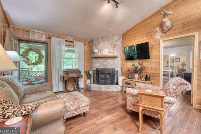 19 Deer Trl, Blairsville, GA 30512 - living room with wooden walls, vaulted ceiling, hardwood / wood-style flooring, and a fireplace
