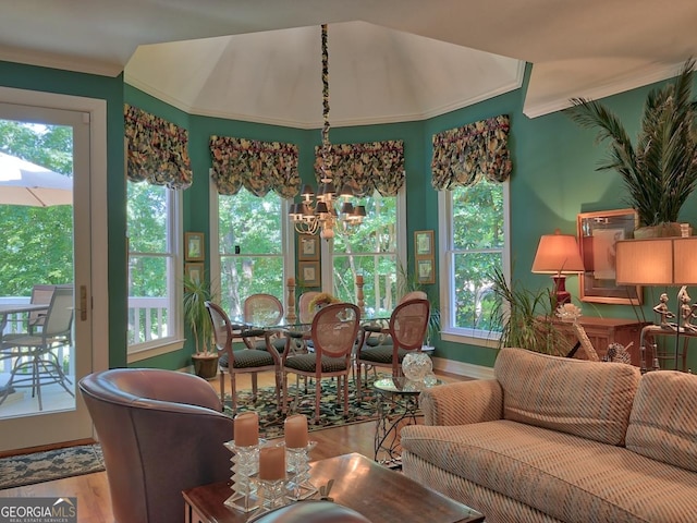 307 Worthing Ln, Mcdonough, GA 30253 - living room with wood finished floors, ornamental molding, healthy amount of natural light, and a chandelier