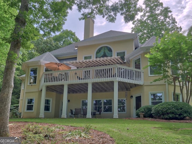 307 Worthing Ln, Mcdonough, GA 30253 - rear view of house with stucco siding, a chimney, a lawn, and a deck