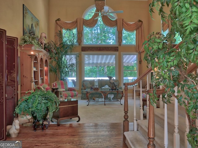 307 Worthing Ln, Mcdonough, GA 30253 - foyer with a ceiling fan, a towering ceiling, plenty of natural light, stairs, and wood finished floors