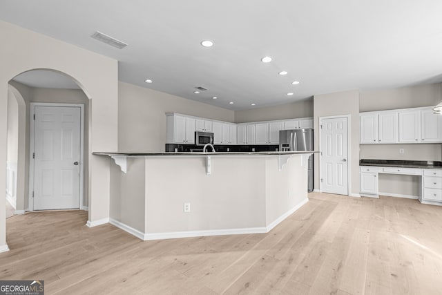 2030 Brook Meadow Dr, Alpharetta, GA 30005 - kitchen featuring stainless steel appliances, a kitchen bar, light wood-style floors, white cabinets, and recessed lighting