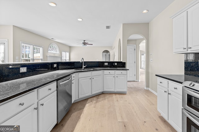 2030 Brook Meadow Dr, Alpharetta, GA 30005 - kitchen featuring dishwasher, stove, a ceiling fan, arched walkways, and light wood finished floors