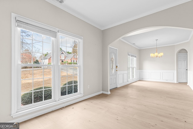 2030 Brook Meadow Dr, Alpharetta, GA 30005 - empty room featuring a chandelier, arched walkways, ornamental molding, light wood-style floors, and wainscoting
