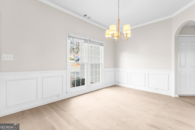 2030 Brook Meadow Dr, Alpharetta, GA 30005 - unfurnished dining area featuring a chandelier, ornamental molding, a wainscoted wall, light wood finished floors, and arched walkways