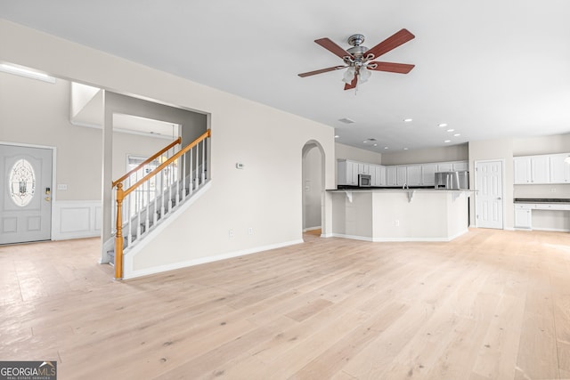 2030 Brook Meadow Dr, Alpharetta, GA 30005 - unfurnished living room with ceiling fan, light wood finished floors, arched walkways, stairs, and recessed lighting