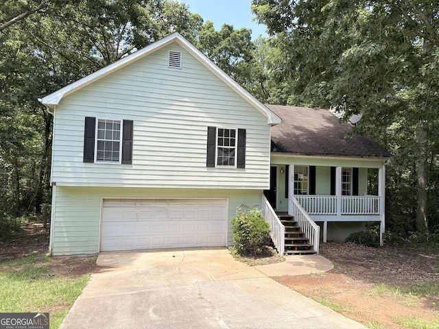 270 Mountain Way, Covington, GA 30016 - split level home featuring covered porch, an attached garage, concrete driveway, and stairway