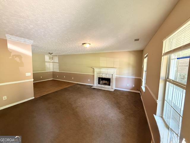 270 Mountain Way, Covington, GA 30016 - unfurnished living room with carpet, baseboards, a textured ceiling, a premium fireplace, and lofted ceiling