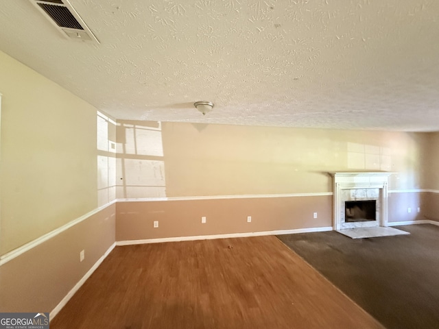 270 Mountain Way, Covington, GA 30016 - unfurnished living room featuring a textured ceiling, wood finished floors, a premium fireplace, and baseboards