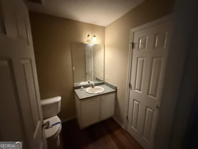 270 Mountain Way, Covington, GA 30016 - half bathroom with vanity, toilet, and wood finished floors