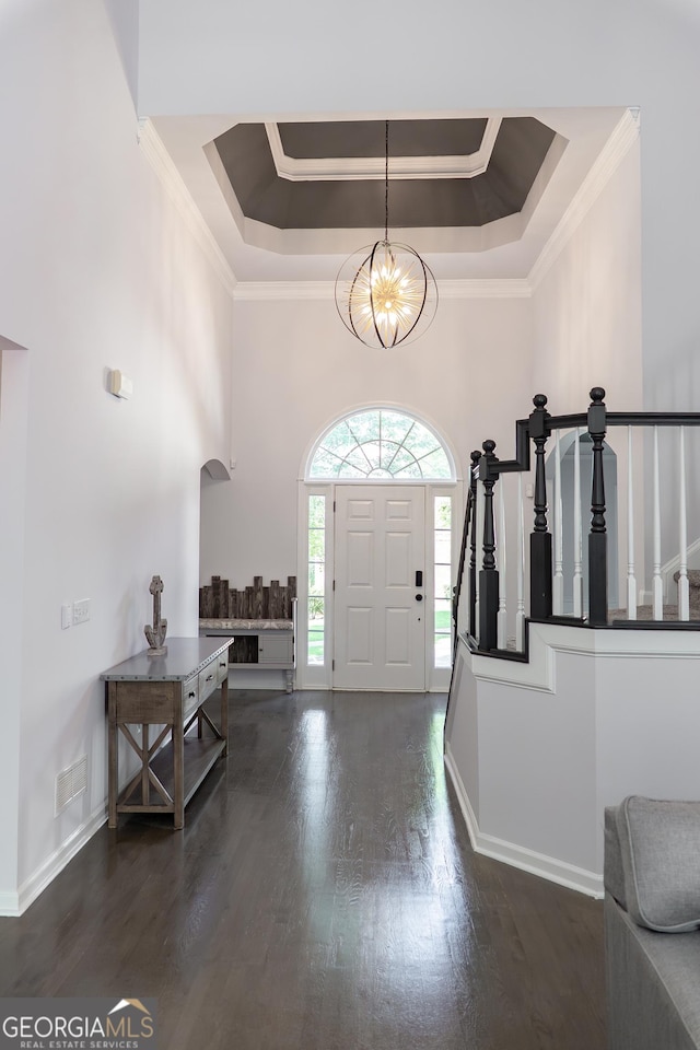 4046 Creekview Ridge Dr, Buford, GA 30518 - entryway featuring a raised ceiling, ornamental molding, dark wood finished floors, a chandelier, and stairs