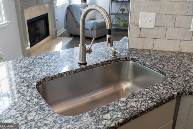 4046 Creekview Ridge Dr, Buford, GA 30518 - detailed view of dark stone countertops and a fireplace