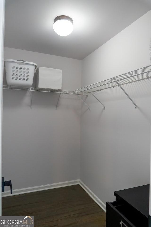 4046 Creekview Ridge Dr, Buford, GA 30518 - walk in closet with dark wood-type flooring