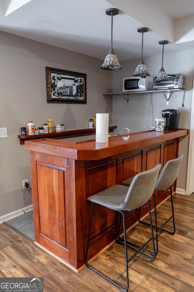 4046 Creekview Ridge Dr, Buford, GA 30518 - indoor dry bar featuring wood finished floors and pendant lighting