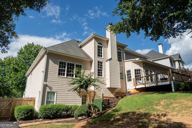 4046 Creekview Ridge Dr, Buford, GA 30518 - rear view of house featuring a chimney, a deck, and roof with shingles