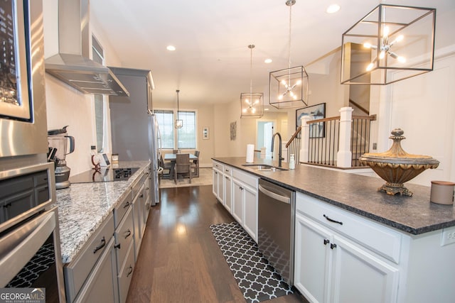 1 Newnan Views Cir, Newnan, GA 30263 - kitchen with appliances with stainless steel finishes, a sink, wall chimney range hood, dark wood finished floors, and a chandelier