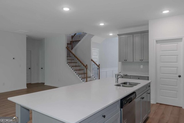 420 Tavistock Ct, Mcdonough, GA 30252 - kitchen featuring dishwasher, a sink, gray cabinets, light wood-type flooring, and recessed lighting